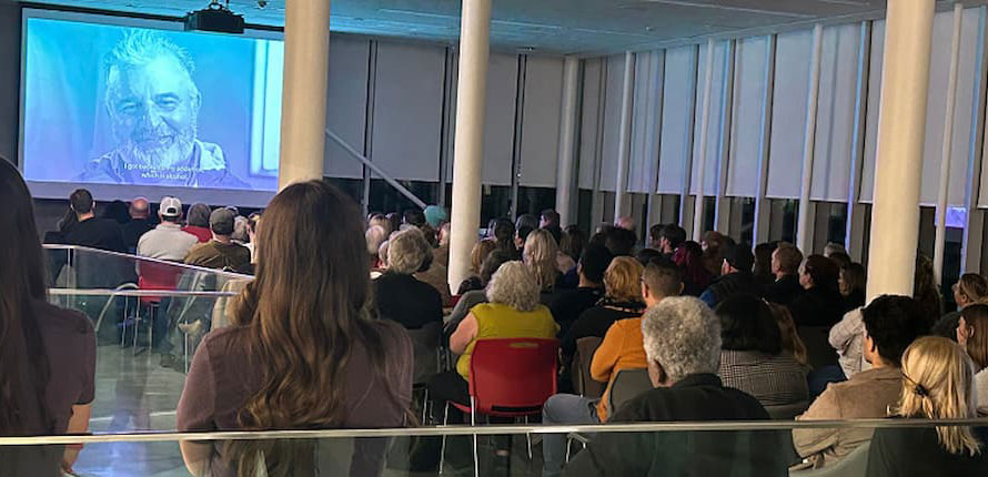 An audience watching a film.