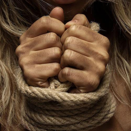 Two hands tied together with a rope