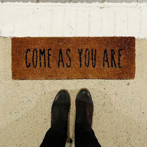 A welcome mat that says "come as you are"
